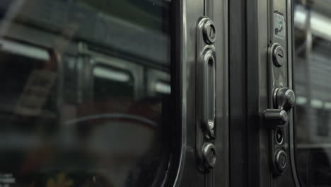 Departing-subway-train-view-from-inside-through-closed-doors