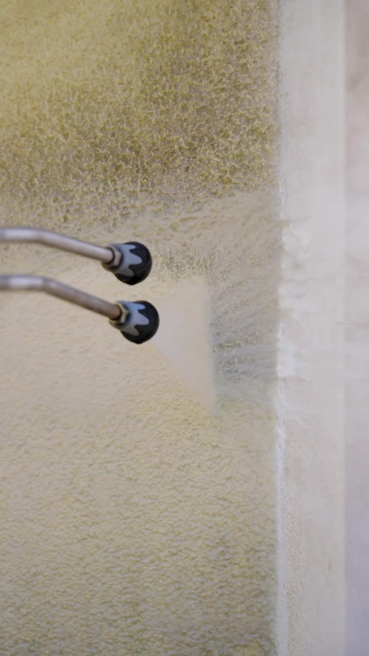 Deep cleaning a beige carpet with powerful water jet from a nozzle
