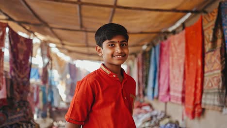 young indian merchant smiling in a traditional market with colorful fabrics hanging, representing local craftsmanship and cultural heritage