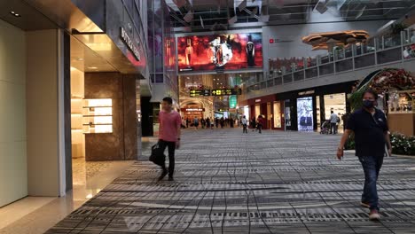 people walking through a decorated shopping mall