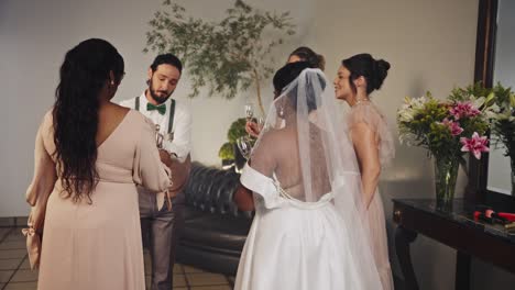 joyful wedding party toasting with champagne