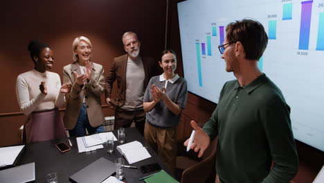 business professionals applauding in a meeting room