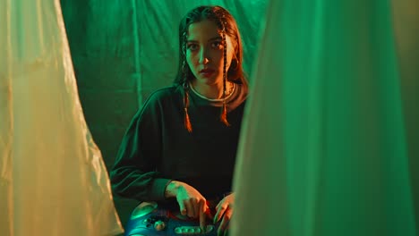 young woman with braids and retro boombox in green-lit setting