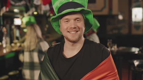man with irish flag at party in pub