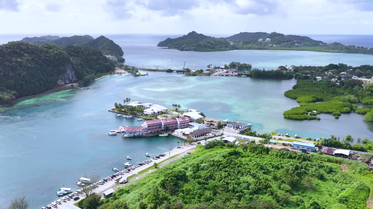 Ripresa aerea con drone di un resort su un'isola tropicale annidato accanto alle limpide acque turchesi della laguna