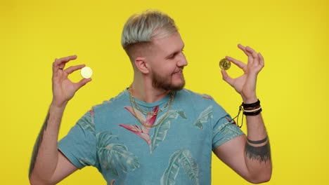 handsome rich stylish tourist man fooling, showing golden bitcoins cryptocurrency investment, mining