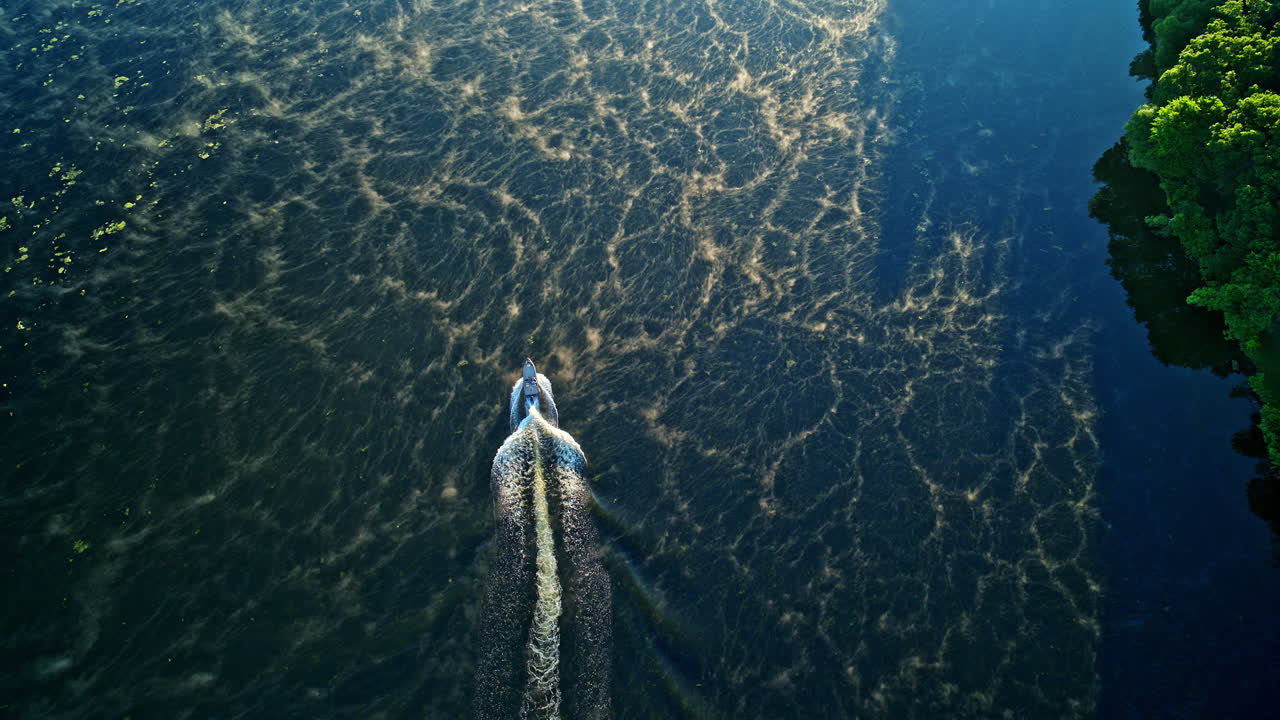 Aerial view of fishing boats on a misty river, filmed by drone.