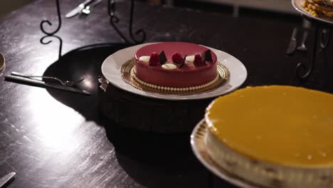 raspberry mousse cake with decorative toppings on a wedding dessert table