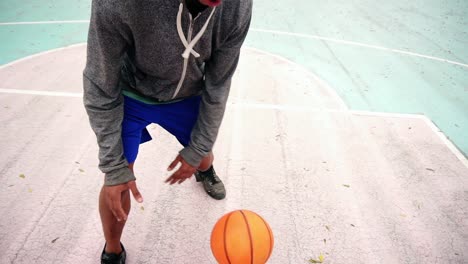 Top-view-of-unrecognizable-african-american-man-practicing-basketball-outside.-Slow-Motion-shot