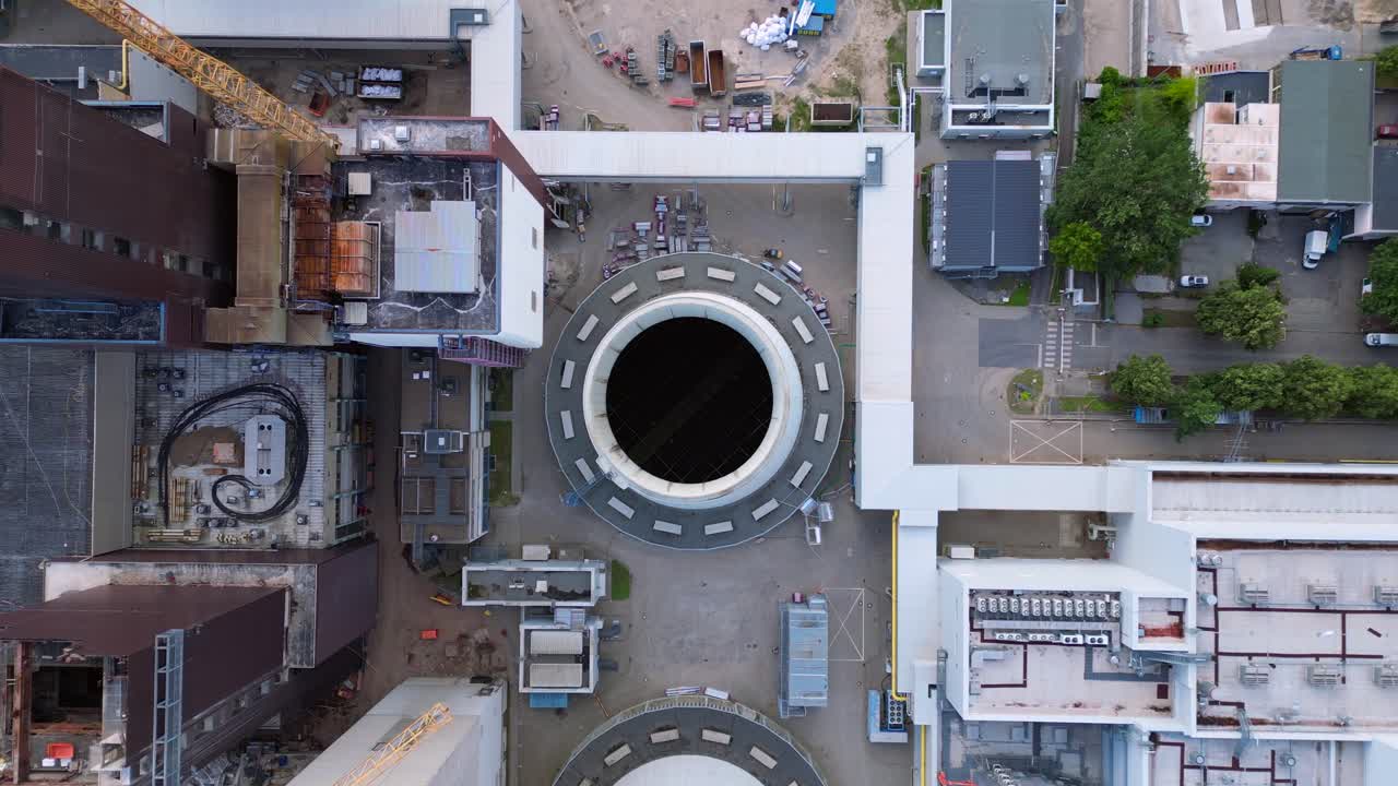 2 crane dismantling a power plant during a demolition process. Perfect aerial view flight drone camera pointing down