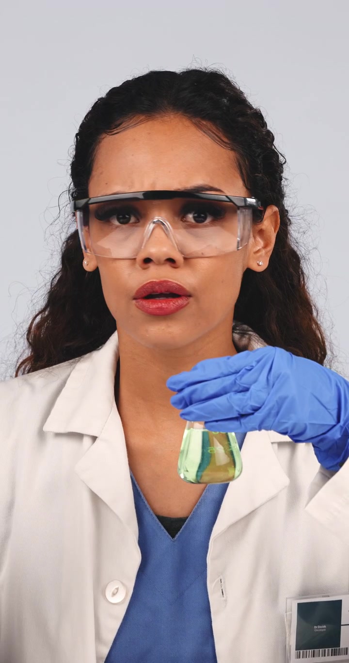 Female Scientist Examining Chemical Solution in Laboratory