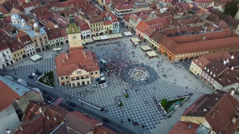 aerial view from above of brasov city centre main square with public gathering - romania