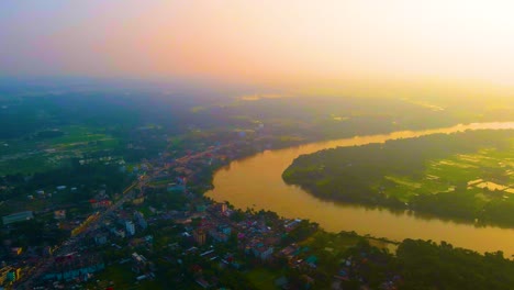 scenic aerial landscape of small town beside river bend at sunset in asia