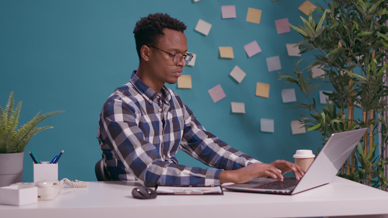 Shocked man doing three wise monkeys gesture at desk