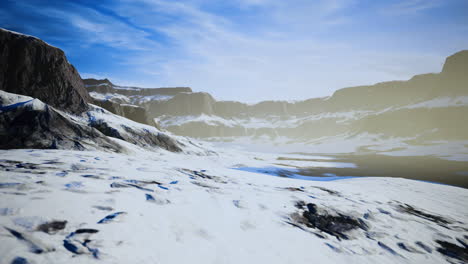 vast frozen landscape with rocky mountains and clear blue skies in daylight