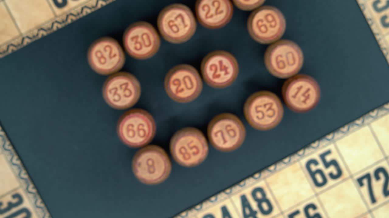 Cinematic close-up rotating smooth zoom out shot from above of a Bingo wooden barrels in a square, woody figures, old numbers background, vintage board game, professional lighting, 4K video