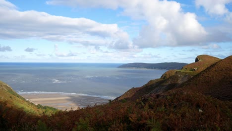 Lush-high-mountain-highlands-coastal-landscape-overlooking-idyllic-beach-shoreline