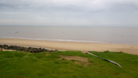 Panning-wide-shot-of-the-coastal-erosion-of-the-cliffs-at-Happisburgh-in-March-2024