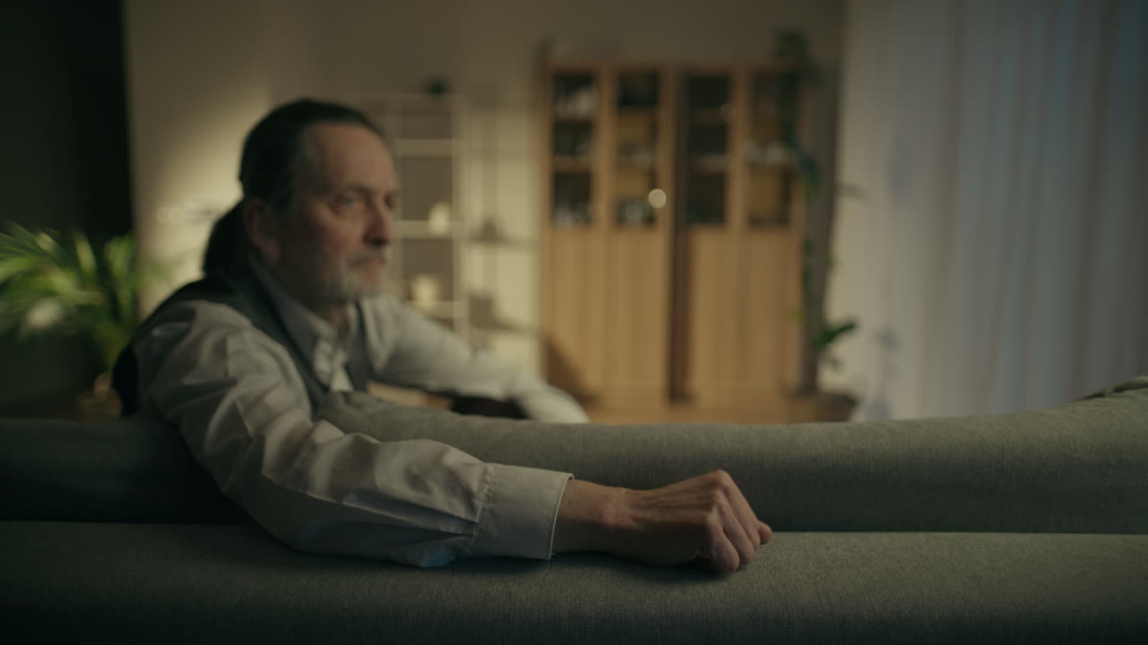 Older Man Resting on Couch in Living Room