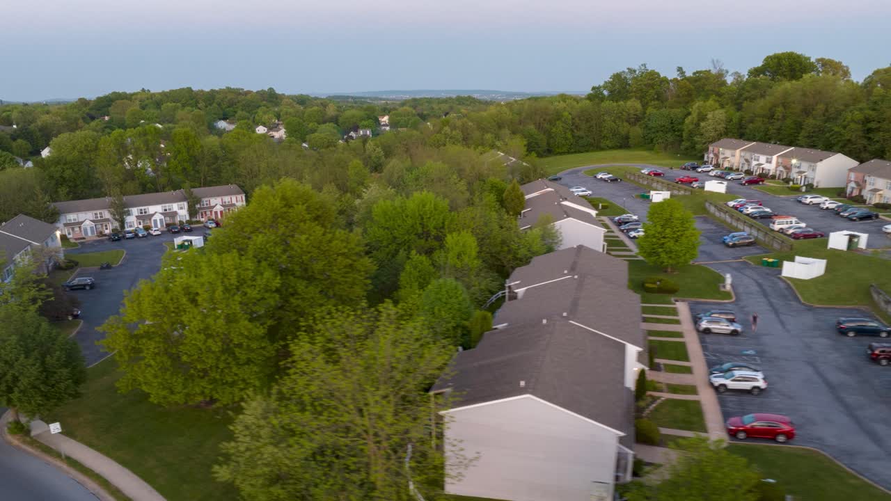 Sunset over residential neighborhood with homes and winding roads