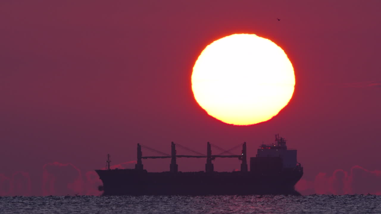 Cinematic aerial shot of Gdynia Orłowo coastline and cliff bathed in sunrise glow