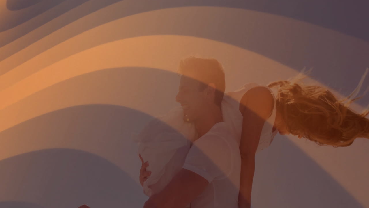Couple having fun with animation over abstract orange wave design background
