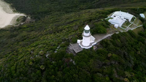 Amazing-drone-shot-of-Smoky-Cape-Lighthouse-revealing-pacific-ocean