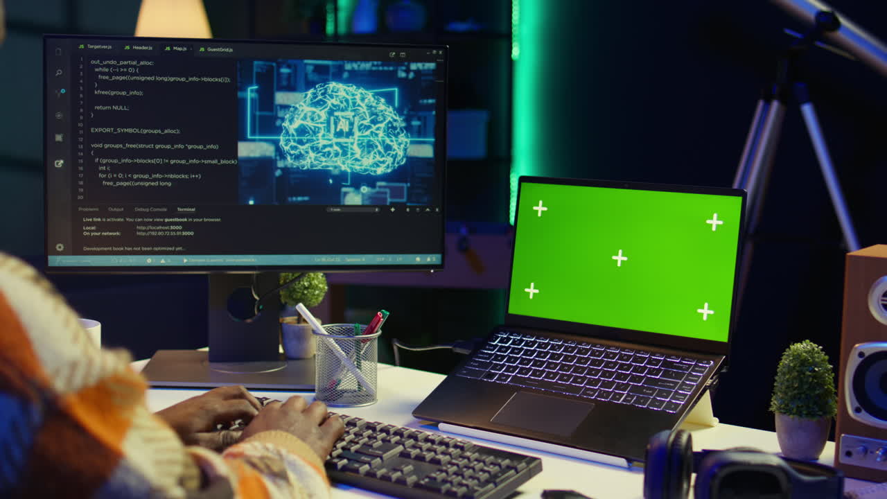 Workspace with computer, laptop and green screen for technology and coding