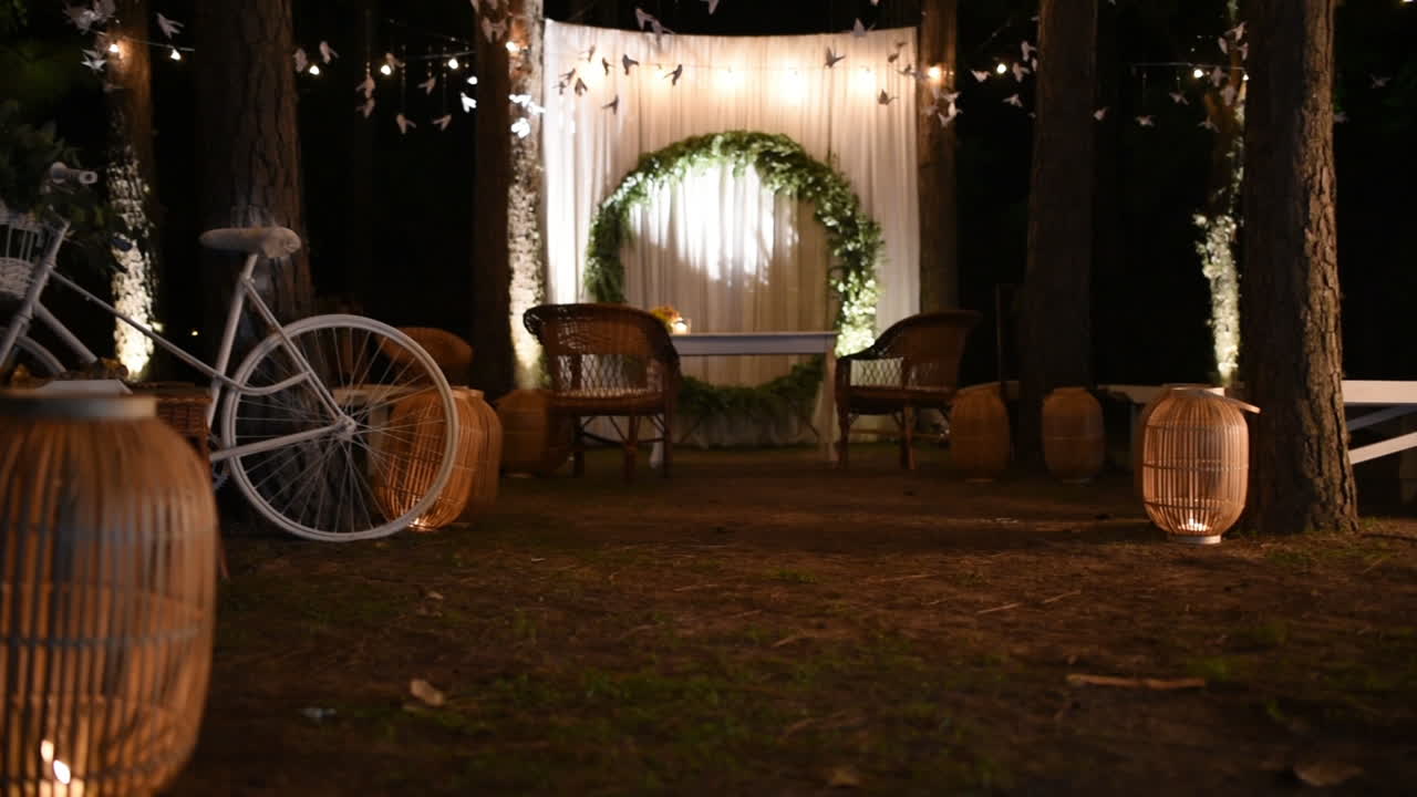 Elegant Vintage Night Wedding Arragements, Love Light Letters, Altar and Bicycle Under Romantic Lights on Trees in Exterior, Pan Shot