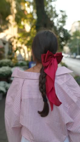 woman with pink shirt and red bow