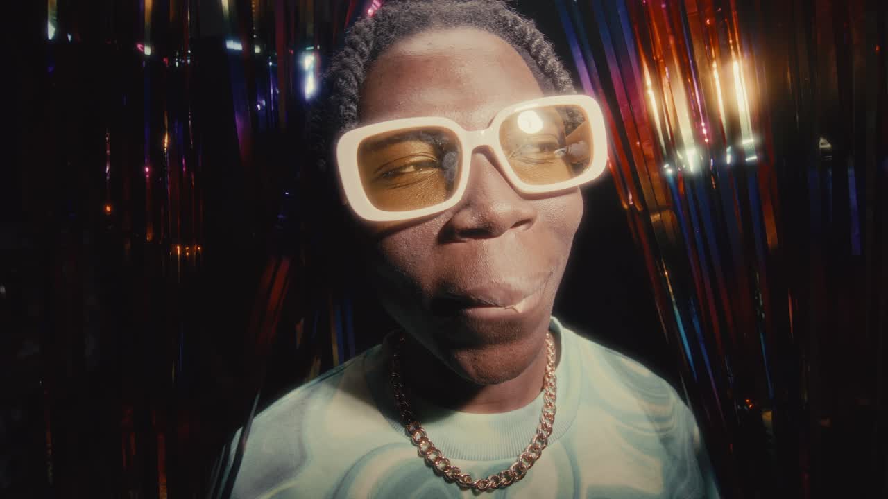 Portrait of African American Man Blowing Bubblegum at Party