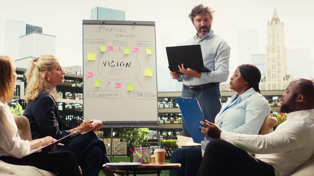 Businessman presenting ideas on whiteboard during informal discussion