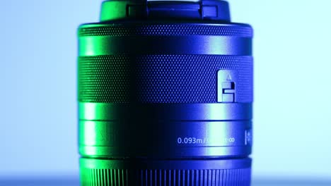 Macro-camera-lens-mount,-studio-video-with-green-and-blue-lights-and-rotating-motion