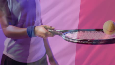 animation of flag of france over african american female tennis player with tennis ball and racket