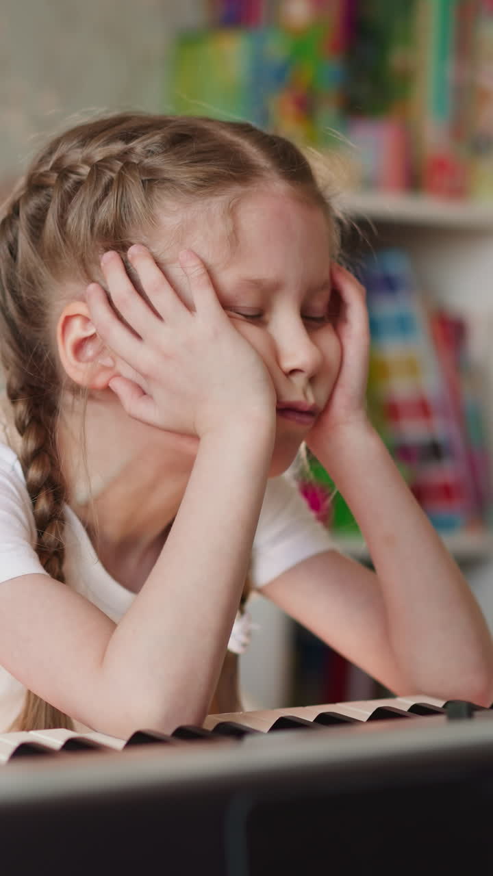 Junior schoolgirl with back braces learns musical sheets in living room. Child with spine injury sits at piano at home. Kid with backpain at music lesson