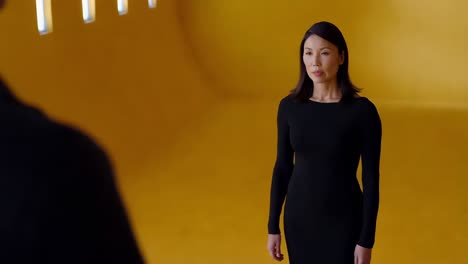 woman in black dress in a yellow room