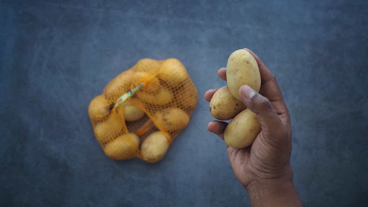 Potatoes in hand and bag
