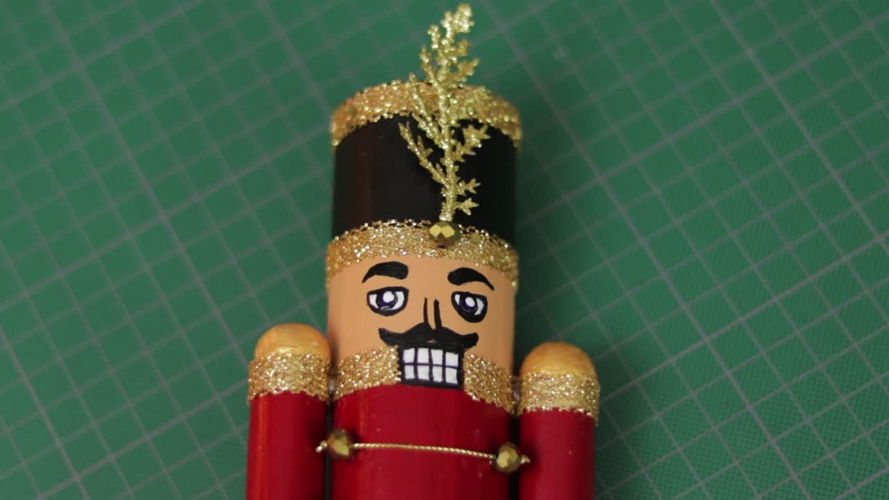 Handmade toy solider christmas nutcracker with glitter on cutting mat