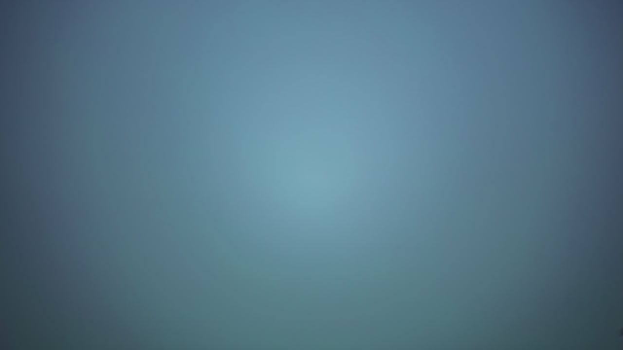 cielo azul dando paso a nubes en rápido movimiento sobre un bosque montañoso, cambio climático dinámico, lapso de tiempo