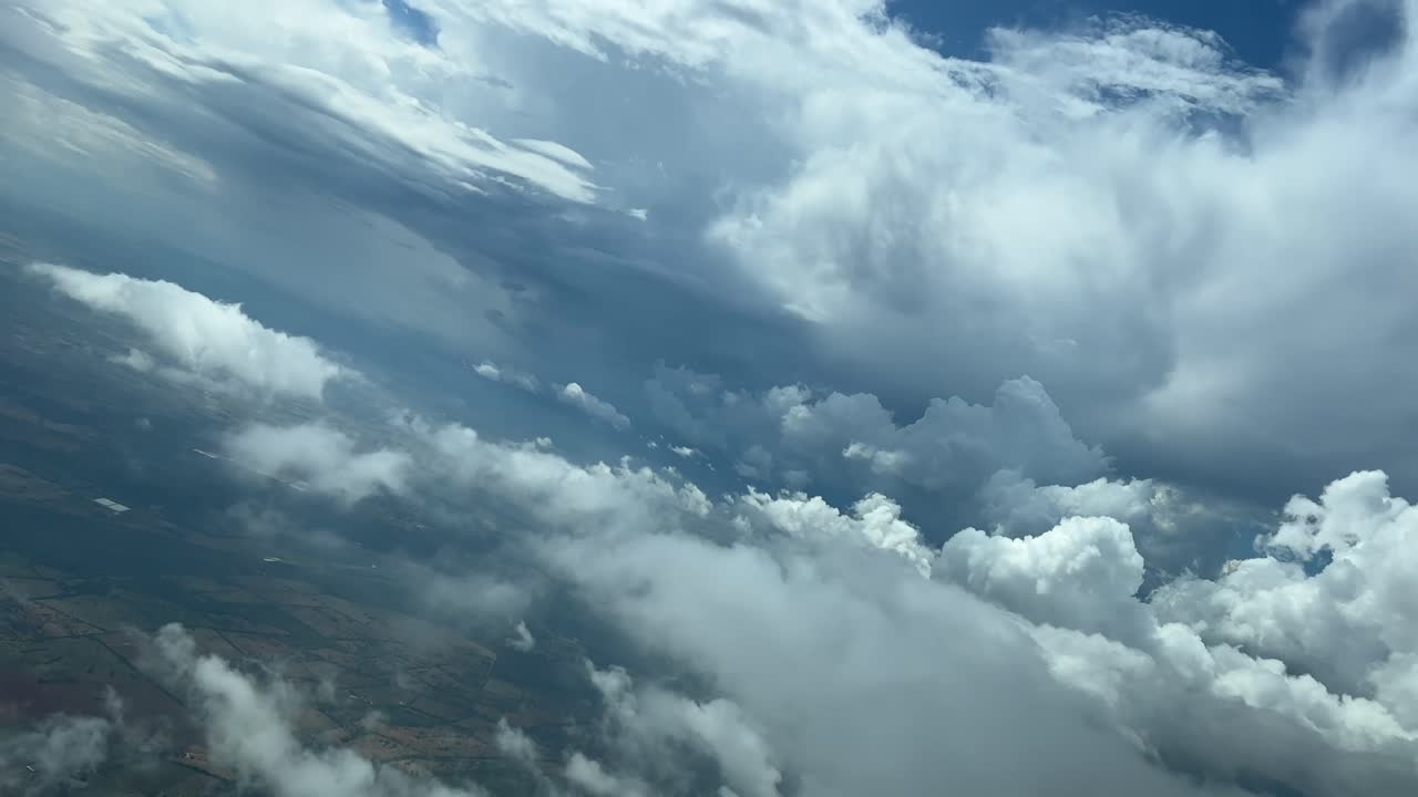 A pilot&rsquo;s perspective of a colorful stormy sky full of clouds during a left turn for the approach to Palma de Mallorca&rsquo;s airport, Spain