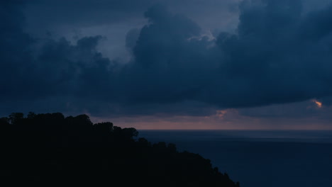 a scenic view of the sea and mountains at sunset