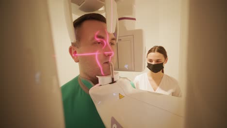 patient undergoing dental x-ray with technician