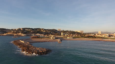 Zoom-out-over-Marseille-beach-during-sunset-with-seagull