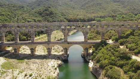 pont du gard roman built aqueduct in southern france crossing the gardon river, aerial pedestal up shot