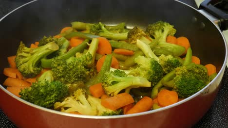 veggie stir fry cooking in a pan with the sauce boiling under the veggies