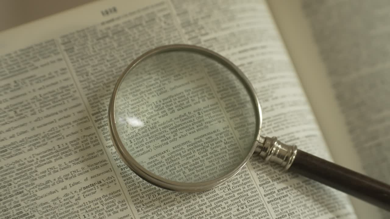 Magnifying glass on large opened book