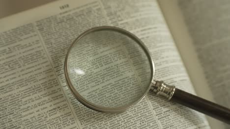 magnifying glass on large opened book