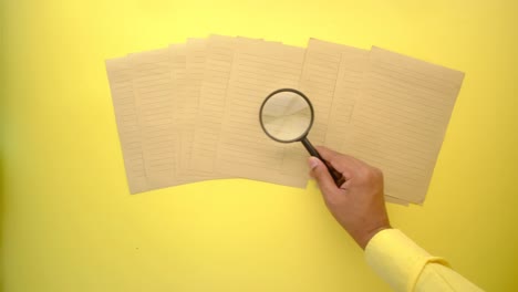 magnifying glass over lined paper