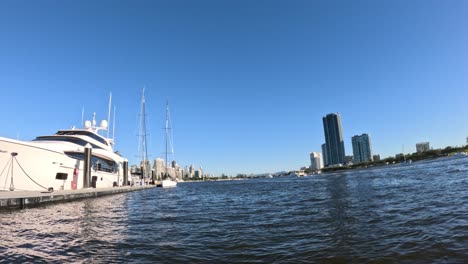 boats moving near city skyline over water