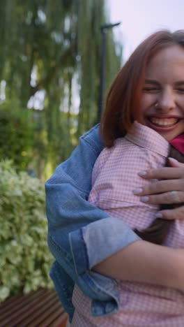 happy hugging friends in a park